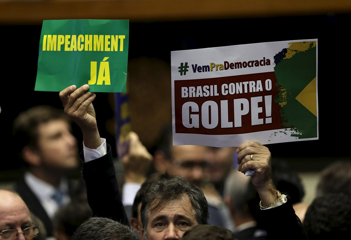 Congressmen, who support or oppose the impeachment, demonstrate before a session to review the request for Brazilian President Dilma Rousseff's impeachment, at the Chamber of Deputies in Brasilia, Brazil April 17, 2016. The signs read "Impeachment yes" and "Brazil against the coup. " REUTERS/Ueslei Marcelino
